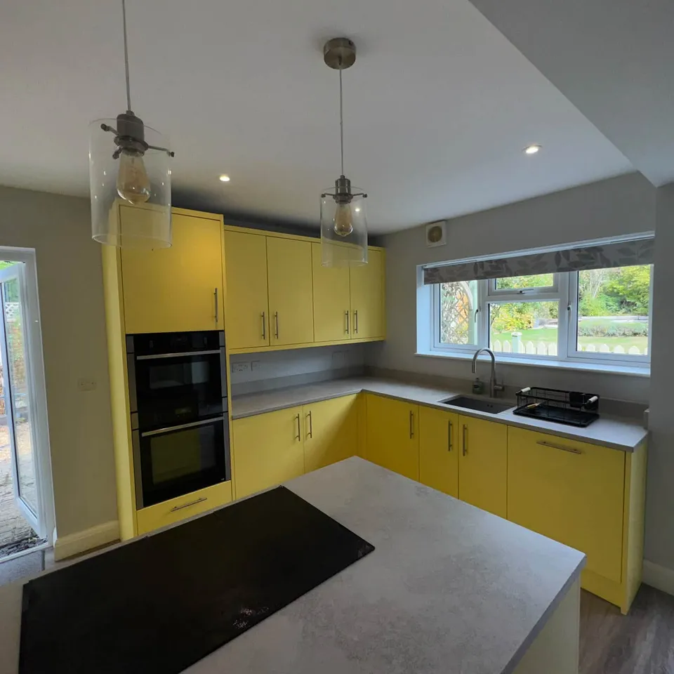 A yellow kitchen with an island, cleaned and ready for new tenants