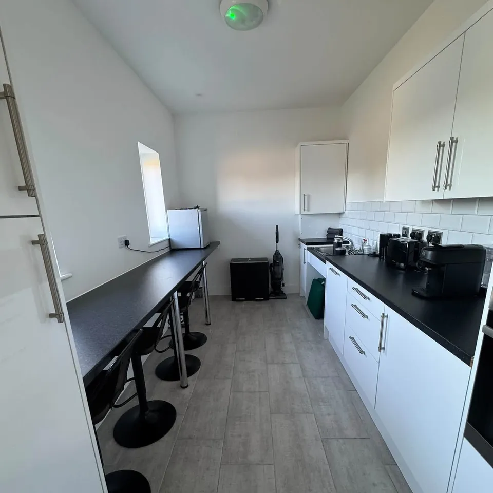 An office kitchen with clean worktops and breakfast bar after a commercial clean