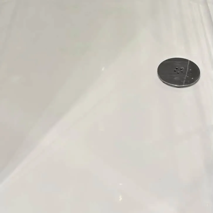 The same shower tray cleaned back to bright white